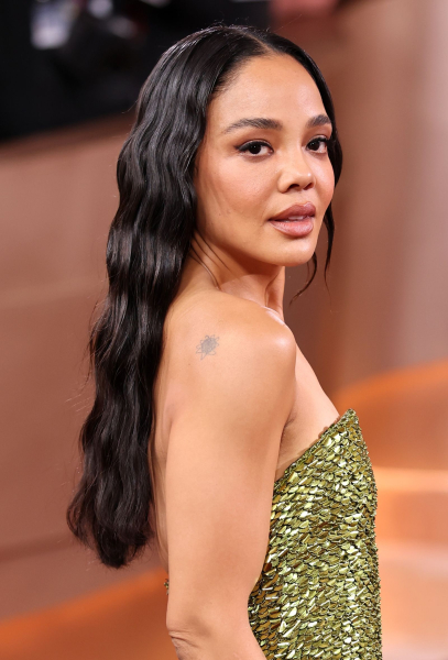 Tessa Thompson posing in a strapless dress at the Golden Globes